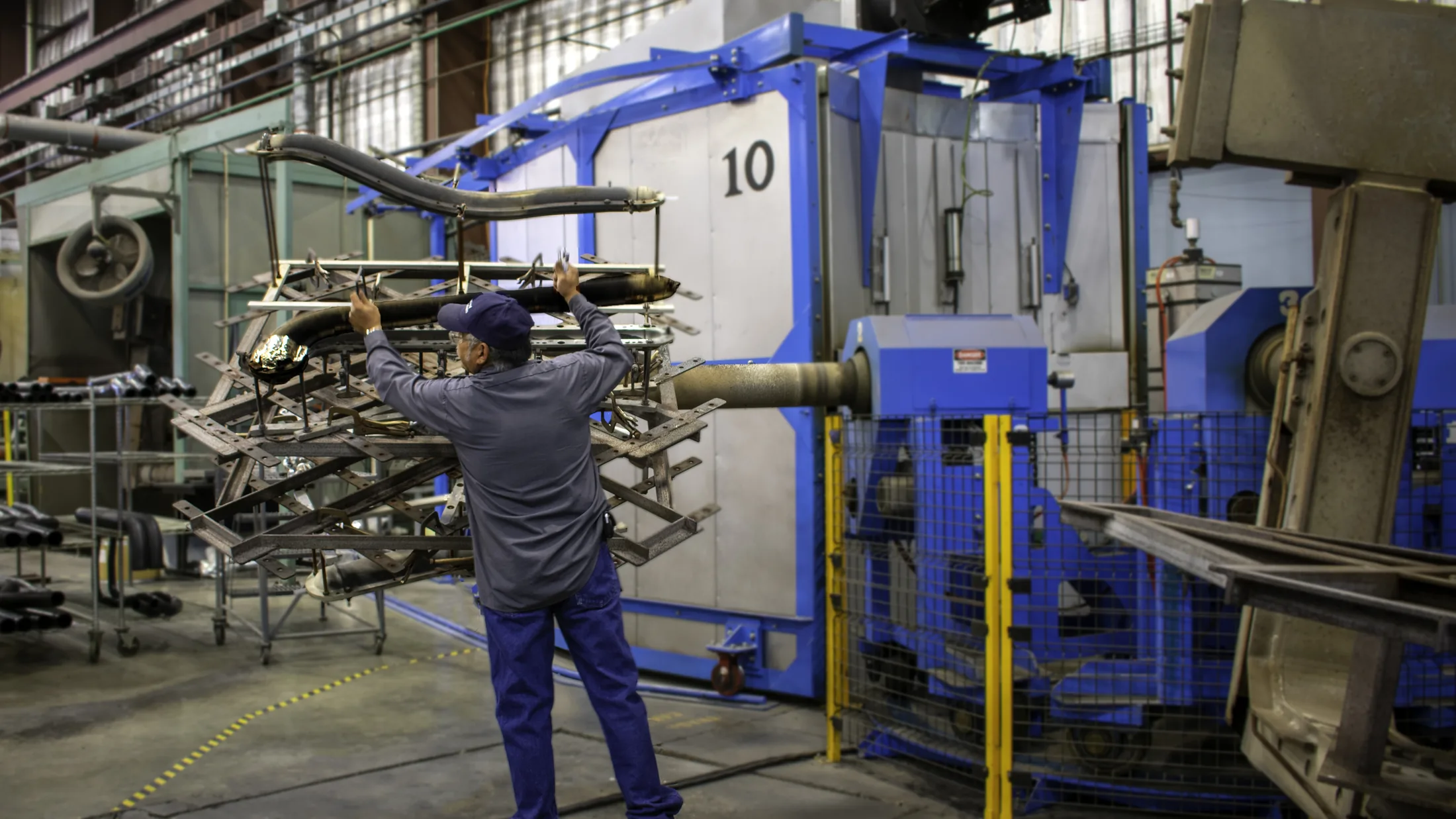 Operator at a rotational molding machine on the Fountain, Colorado floor